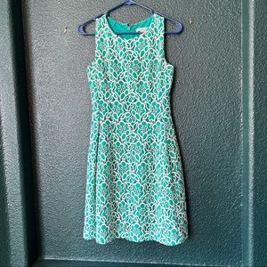 Flattering green and white dress with floral detailing.